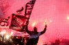 PAOK fans cheer on their team during a Greek Super League soccer match against Levadiakos in Thessaloniki, northern Greece, on Sunday, April 21, 2019. (AP Photo/Giannis Papanikos)