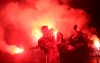 PAOK players onboard a bus celebrate with fans the Greek Super League championship title in front of the White Tower, in Thessaloniki, northern Greece, early Monday, April 22, 2019. PAOK won the Greek league with a round to spare after beating Levadiakos 5-0, 34 years after the last time the team won the championship. (AP Photo/Giannis Papanikos)