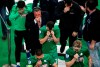 Panathinaikos' players leave the pitch as they trying to avoid teargas thrown by the police during clashes with fans, inside the Athens' Olympic stadium, in Athens, Sunday, March 17, 2019. The derby between Greek league archrivals Panathinaikos and Olympiakos has been abandoned after a small number of Panathinaikos fans clashed with police outside Athens' Olympic stadium. (InTime Sports via AP)