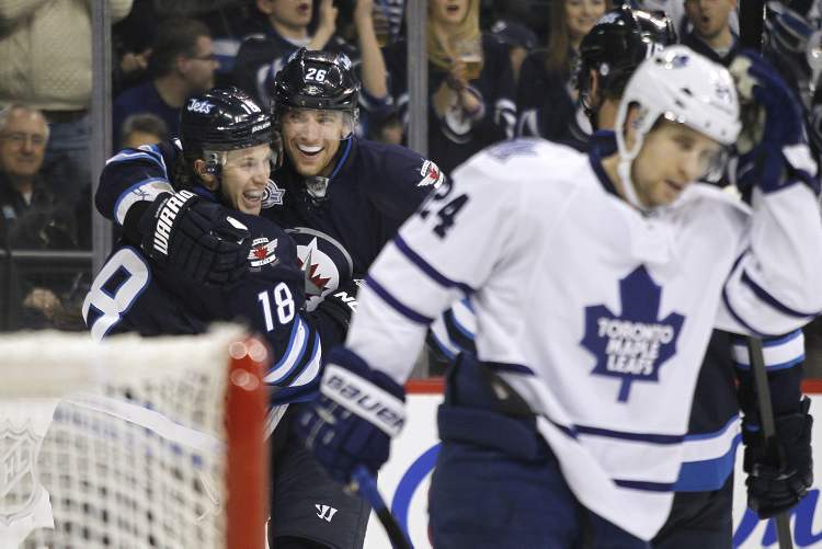 John Woods / Winnipeg Free Press
Winnipeg Jets' Bryan Little (18) and Blake Wheeler (26) celebrate the Jets' second goal against John-Michael Liles (24) and the Toronto Maple Leafs' during second-period action Tuesday. Little's goal proved to be the winner.
