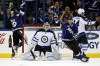 Mike Carlson / Reuters
Tampa Bay's Cory Conacher (left) and Benoit Pouliot celebrate a goal as Winnipeg Jets goalie Ondrej Pavelec and defenceman Grant Clitsome resign themselves to the cruel fact.