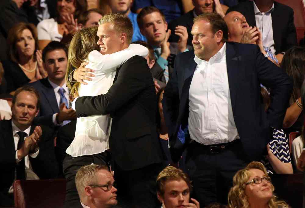 Bill Streicher / USA TODAY
Nikolaj Ehlers gets a hug from family members (including father Heinz Ehlers, right) after being selected as the number nine overall pick to the Winnipeg Jets in the first round of the 2014 NHL Draft at Wells Fargo Center.