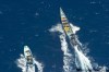 AIR CREW / HMCS WINNIPEG
Pirate skiffs flee HMCS Winnipeg last month. Defence Minister Peter MacKay (below, left), aboard the ship, got a demonstration of its capabilities.