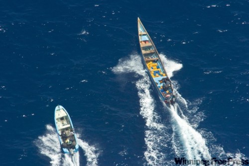 AIR CREW / HMCS WINNIPEG
Pirate skiffs flee HMCS Winnipeg last month. Defence Minister Peter MacKay (below, left), aboard the ship, got a demonstration of its capabilities.