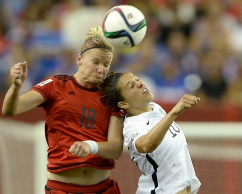 Germany's Alexandra Popp (18) and USA's Carli Lloyd (10) go up for a header during first half Women's World Cup semi-final soccer in Montreal on Tuesday, June 30, 2015. THE CANADIAN PRESS/Ryan Remiorz