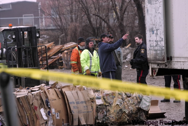Police talk to some men at the scene of a workplace accident Monday morning in which a man was seriously injured. The accident happened about 10:30 at Western Scrap Metal Inc., 18 Sutherland Avenue.