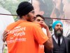 NDP leader Jagmeet Singh laughs as he reads the slogan on a volunteer's shirt while taking photos following an event in Brampton, Ont., Thursday, September 12, 2019. THE CANADIAN PRESS/Adrian Wyld