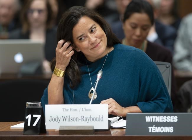 Jody Wilson Raybould adjusts her earpiece as she waits to appear in front of the Justice committee in Ottawa, Wednesday February 27, 2019. THE CANADIAN PRESS/Adrian Wyld