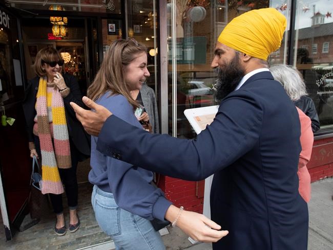 NDP Leader Jagmeet Singh speaks with ladies as they leave a shop in Saint-Hyacinthe, Que. Sunday, September, 15, 2019. As the federal election campaign began last week, Canada's main political parties couldn't escape Quebec's internal politics and a renewed nationalism championed by the provincial government.THE CANADIAN PRESS/Adrian Wyld