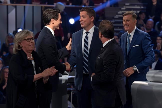 Liberal leader Justin Trudeau shakes hands with Conservative leader Andrew Scheer as People's Party of Canada leader Maxime Bernier, Bloc Quebecois leader Yves-Francois Blanchet and Green Party leader Elizabeth May leave the stage following the Federal leaders debate in Gatineau, Que. on Monday October 7, 2019. THE CANADIAN PRESS/Justin Tang