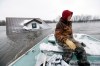 Richard Tsong-Taatarii / The Associated Press
Doug Stensgaard uses one of his family's boats to get back to their home from the Red River near Fargo on Wednesday.