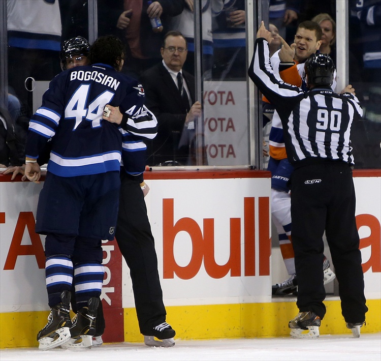 Trevor Hagan / Winnipeg Free Press
Zach Bogosian gets into a scuffle with Kyle Okposo near the end of the second period Saturday after the Islanders player elbowed him earlier in the frame.