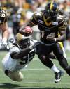 Darren Calabrese / the canadian press
Hamilton Tiger-Cats' DeAndra Cobb, right, avoids the tackle by Winnipeg Blue Bombers' Moton Hopkins during first-half CFL pre-season action against the Winnipeg Blue Bombers in Hamilton Sunday.
