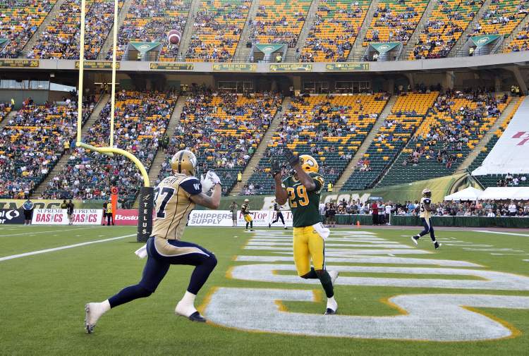 Jason Franson / The Canadian Press
Bombers receiver Rory Kohlert (left) tries to stop the interception by Edmonton's Chris Thompson Saturday in Edmonton.
