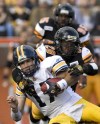 CHRIS YOUNG / THE CANADIAN PRESS
Blue Bombers QB Stefan LeFors is hauled down by Hamilton Tiger-Cats linebacker Jamall Johnson Saturday during first-half CFL action at Ivor Wynne Stadium. The Tiger-Cats went on to win the game 25-13.