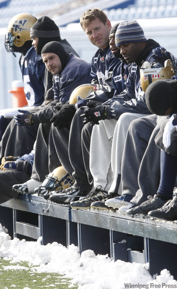 JOE.BRYKSA@FREEPRESS.MB.CA
Winnipeg Blue Bombers Doug Brown, centre, and teammates keep their feet warm during practice Saturday morning at Canad Inns Stadium in Winnipeg - Winnipeg received it's first dump of snow and kept crews busy preparing the field for the team. The Bombers travelled to Hamilton Sunday for their game against the Hamilton Tiger-Cats on Monday.