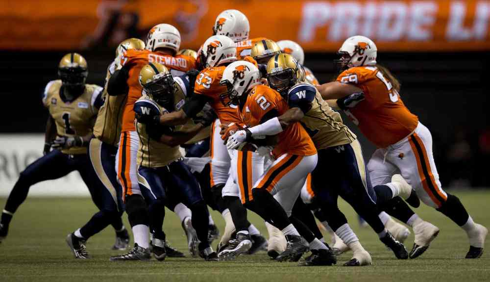 Darryl Dick / The Canadian Press
Winnipeg Blue Bombers' Maurice Leggett, second right, sacks B.C. Lions' quarterback Kevin Glenn (2) during the second half of a CFL football game in Vancouver, B.C., on Friday July 25, 2014.