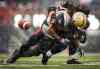 Jeff McIntosh / The Canadian Press
Winnipeg Blue Bombers' Paris Cotton, right, fumbles the ball as he is tackled by Calgary Stampeders' Juwan Simpson, during the first half of Saturday's game in Calgary.