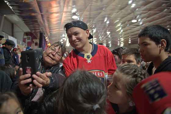 Brady Keeper poses for a selfie with a fan at a homecoming party at the Cross Lake arena in this file photo. (Melissa Martin / Free Press files)