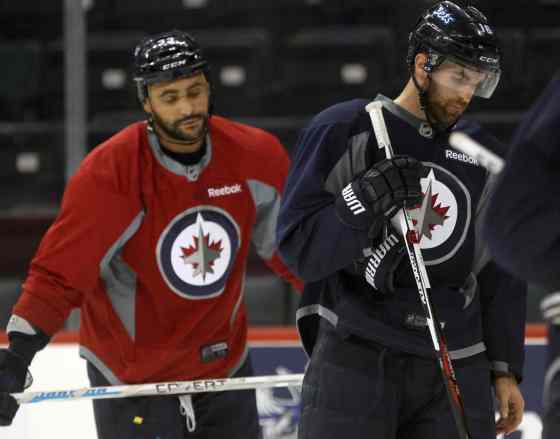 JOE BRYKSA / WINNIPEG FREE PRESSDustin Byfuglien, left, and Captain Andrew Ladd at practice this morning.