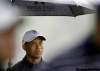 MEL EVANS / THE ASSOCIATED PRESS
A whole lot of rain has fallen on Tiger Woods over the past nine months. Here he waits in the rain on the eighth hole during the Pro-Am round at The Barclays tournament Wednesday in New Jersey.