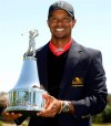 Tiger Woods holds the championship trophy after winning the Arnold Palmer Invitational golf tournament in Orlando, Fla., Monday, March 25, 2013. Woods won with a score of 13-under-par.(AP Photo/Phelan M. Ebenhack)