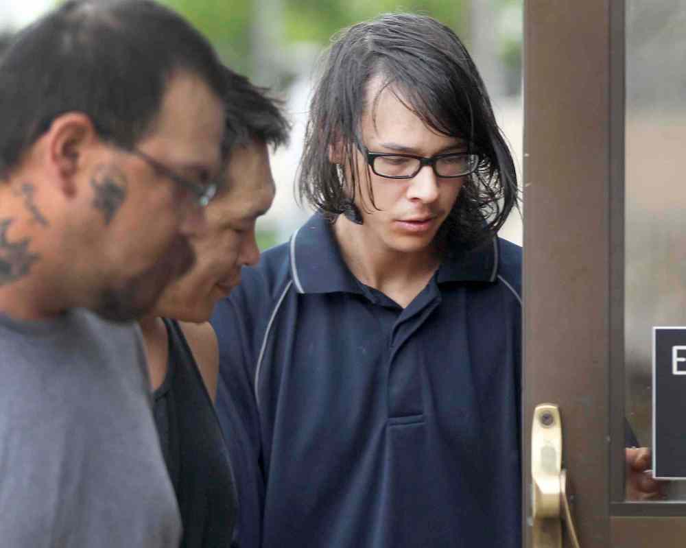 Joe Bryksa / Winnipeg Free Press
Jason Conway, 21, of MacGregor, Man., (right) is led into the provincial court house Monday in Portage la Prairie. He has been charged with first-degree murder in connection with the death of 96-year-old Niels