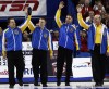 Nathan Denette/ The Canadian Press
Alberta lead Ben Heber, (left to right) second Marc Kennedy, third John Morris and skip Kevin Martin wave to the crowd after defeating Manitoba 10-4.