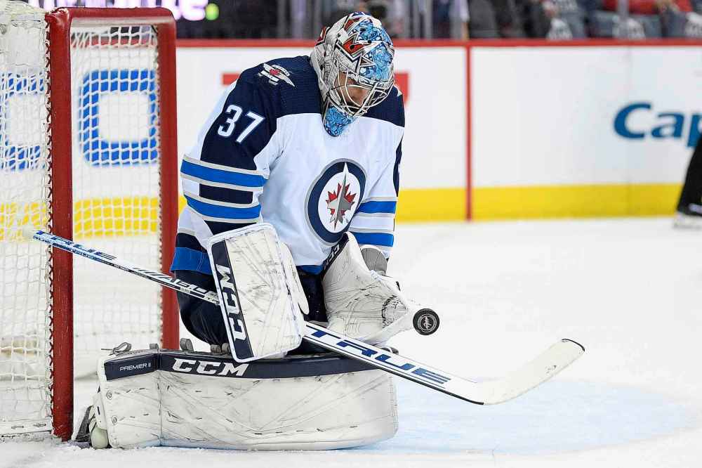 NICK WASS / THE ASSOCIATED PRESS
Winnipeg Jets goaltender Connor Hellebuyck (37) stops the puck during the first period of an NHL hockey game against the Washington Capitals, Sunday, March 10, 2019, in Washington.
