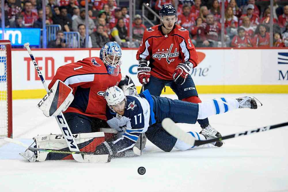 NICK WASS / THE ASSOCIATED PRESS
Winnipeg Jets center Adam Lowry (17) collides into Washington Capitals goaltender Pheonix Copley (1) during the second period of an NHL hockey game, Sunday, March 10, 2019, in Washington. Also seen is Capitals defenseman Dmitry Orlov (9), of Russia.