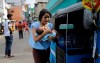 A Sri Lankan woman living near St. Anthony's shrine runs for safety with her infant after police found explosive devices in a parked vehicle in Colombo, Sri Lanka, Monday, April 22, 2019. Sri Lankan authorities blame seven suicide bombers of a domestic militant group for coordinated Easter bombings that ripped through Sri Lankan churches and luxury hotels which killed and injured hundreds of people. It was Sri Lanka's deadliest violence since a devastating civil war in the South Asian island nation ended a decade ago. (AP Photo/Eranga Jayawardena)