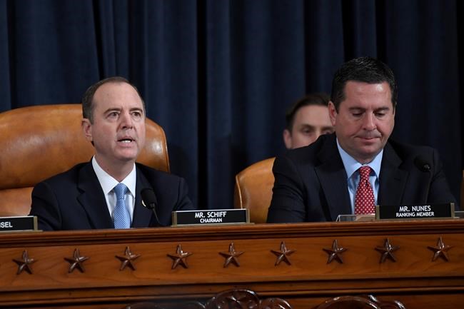 House Intelligence Committee Chairman Adam Schiff of Calif., left, speaks as Rep. Devin Nunes, R-Calif., the ranking member on the committee listens during the House Intelligence Committee on Capitol Hill in Washington, Wednesday, Nov. 13, 2019, in the first public impeachment hearing of President Donald Trump's efforts to tie U.S. aid for Ukraine to investigations of his political opponents. (AP Photo/Susan Walsh)