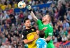 Uerdingen's goalkeeper Lukas Koenigshofer, right, and Dortmund's Mats Hummels, left, challenge for the ball during the German soccer cup, DFB Pokal, first Round match between KFC Uerdingen 05 and Borussia Dortmund in Duesseldorf, Germany, Friday, Aug.9, 2019. (AP Photo/Martin Meissner)