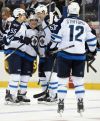 Kathy Kmonicek / The Associated Press
Jets players swarm rookie Nikolaj Ehlers (second from left) after the nifty Dane scored his first NHL goal Tuesday in New York.