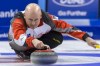 Canada's team skip Kevin Koe delivers a stone during a play-off game between Canada and Denmark, at the World Men's Curling Championship 2016 in the St. Jakobshalle arena in Basel, Switzerland, on Friday, April 8, 2016. Denmark and Canada face each other in the Page 1-2 playoff Friday, with a place in Sunday’s gold-medal game on the line. (Georgios Kefalas/Keystone via AP)