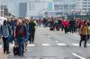 People walk away from Brussels airport after explosions rocked the facility in Brussels, Belgium Tuesday March 22, 2016. Explosions rocked the Brussels airport and the subway system Tuesday, just days after the main suspect in the November Paris attacks was arrested in the city, police said. (AP Photo/Geert Vanden Wijngaert)