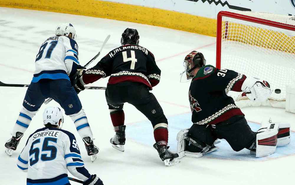 Winnipeg Jets left wing Kyle Connor (81) scores a goal past Arizona Coyotes defenseman Niklas Hjalmarsson (4) and goaltender Calvin Pickard (30) during the second period of an NHL hockey game Saturday, April 6, 2019, in Glendale, Ariz. (AP Photo/Ross D. Franklin)