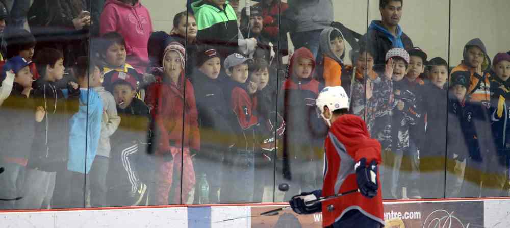 Trevor Hagan / Winnipeg Free Press
Devin Setoguchi passes a puck to young spectators who are participating in the Aboriginal Minor Hockey Tournament after they crowded in to watch the Winnipeg Jets practice at the Iceplex. Fifty-seven teams from more than 10 communities are represented.