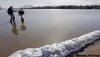 M. Spencer Green / The Associated Press
Darrell Nelson wades through water caused by overland flooding from the Sheyenne River to check his mail outside Harwood, N.D.