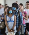 LM Otero / AP Photo
Miranda Carnewro, 18, and Jorge Juarez, 18, wear masks as they wait to clear U.S. Customs crossing from Ciudad Juarez, Mexico, into El Paso, Texas.