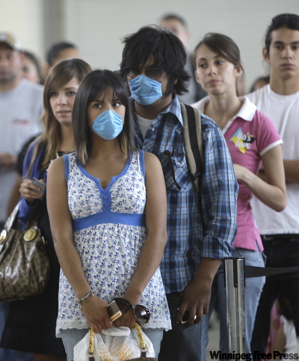 LM Otero / AP Photo
Miranda Carnewro, 18, and Jorge Juarez, 18, wear masks as they wait to clear U.S. Customs crossing from Ciudad Juarez, Mexico, into El Paso, Texas.