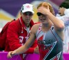 Paula Findlay of Canada resumes the run course after stopping with team doctor Steve Keeler (back) during Triathlon competition at the 2012 Olympic Games in London on Saturday, August 4, 2012. THE CANADIAN PRESS/Frank Gunn