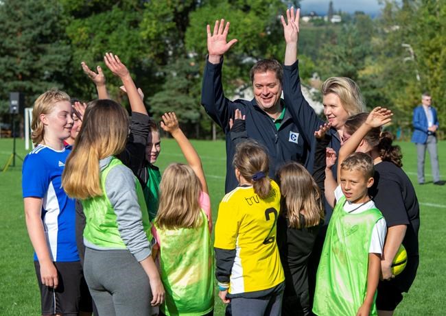 Federal Conservative leader Andrew Scheer and his wife Jill conduct a cheer with children playing soccer at a campaign event in Kelowna, B.C. on Monday September 16, 2019. THE CANADIAN PRESS/Frank Gunn
