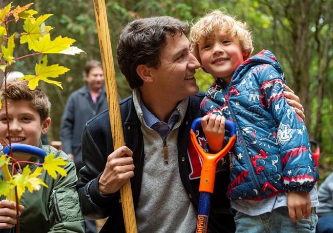 Federal Liberal leader Justin Trudeau plants a tree with his sons Hadrien (right) and Xavier at the Frank Conservation Area in Plainfield, Ont. on Sunday, October 6, 2019. THE CANADIAN PRESS/Frank Gunn