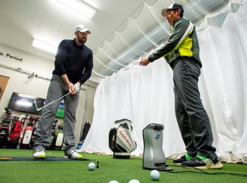 Carson Hau (right), Director of Technology at The Golf Lab, and student Matthew Parkinson practice during a training session at The Golf Lab in King City, Ontario on Saturday May 4, 2019. THE CANADIAN PRESS/Frank Gunn