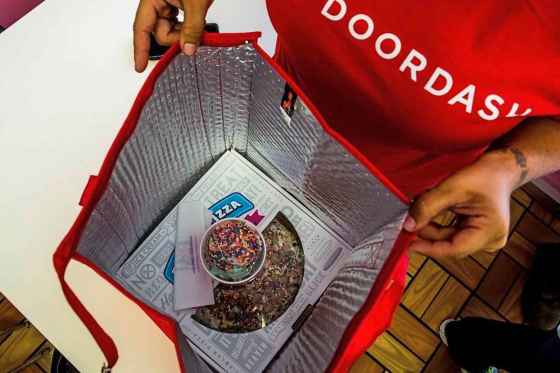 A DoorDash driver starts to bag up an order in Daly City, Calif. (Christie Hemm Klok / The Washington Post)