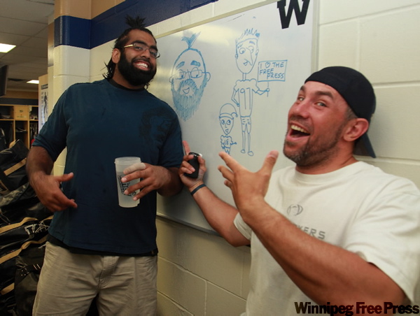 KEN GIGLIOTTI / WINNIPEG FREE PRESS
Blue Bomber Chris Cvetkovic is the team artist, comedian and long-snapper. Obby Khan (left) gets a big kick out of a recent Cvetkovic caricature drawn in the locker-room.