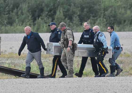 Tessa Vanderhart / Winnipeg Free PressMetal coffins containing what's believed to be the remains of two manhunt suspects are loaded on to separate RCMP planes at the Gillam airport Wednesday evening. An autopsy in Winnipeg will confirm their identity and cause of death.