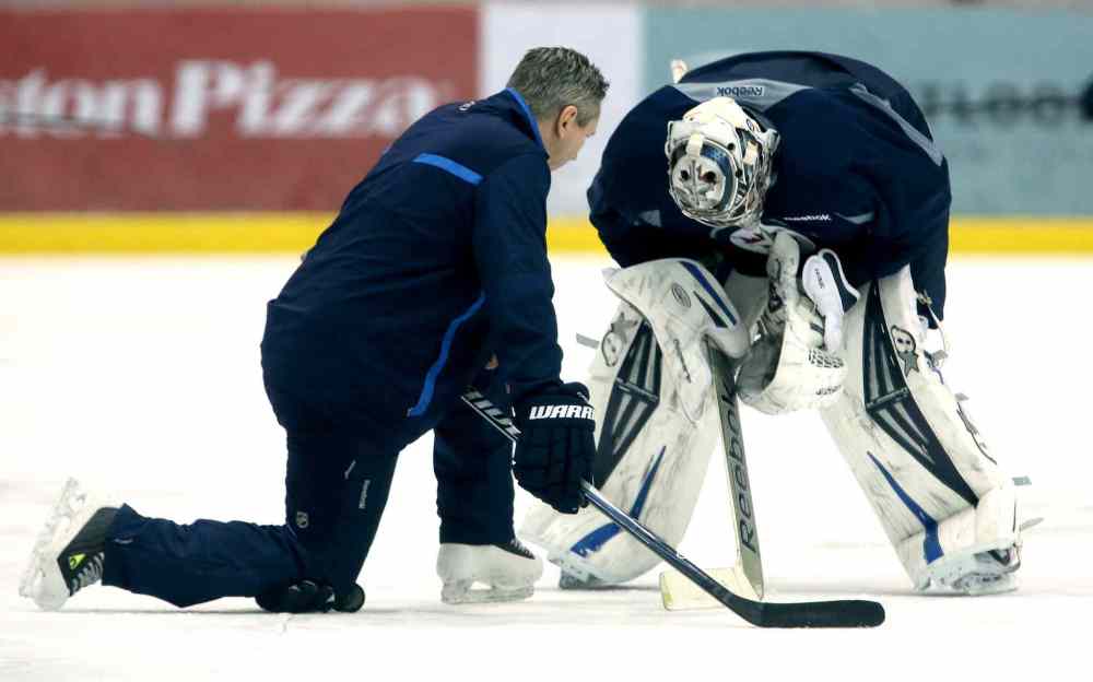 Trevor Hagan / Winnipeg Free Press
Winnipeg Jets' goaltending coach Wade Flaherty talks to goaltender Ondrej Pavelec (31) during practice at the MTS Iceplex Sunday.
