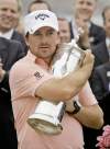 ERIC RISBERG / THE ASSOCIATED PRESS
Graeme McDowell gives the U.S. Open trophy a bear hug after winning golf’s battle of attrition at Pebble Beach Sunday.